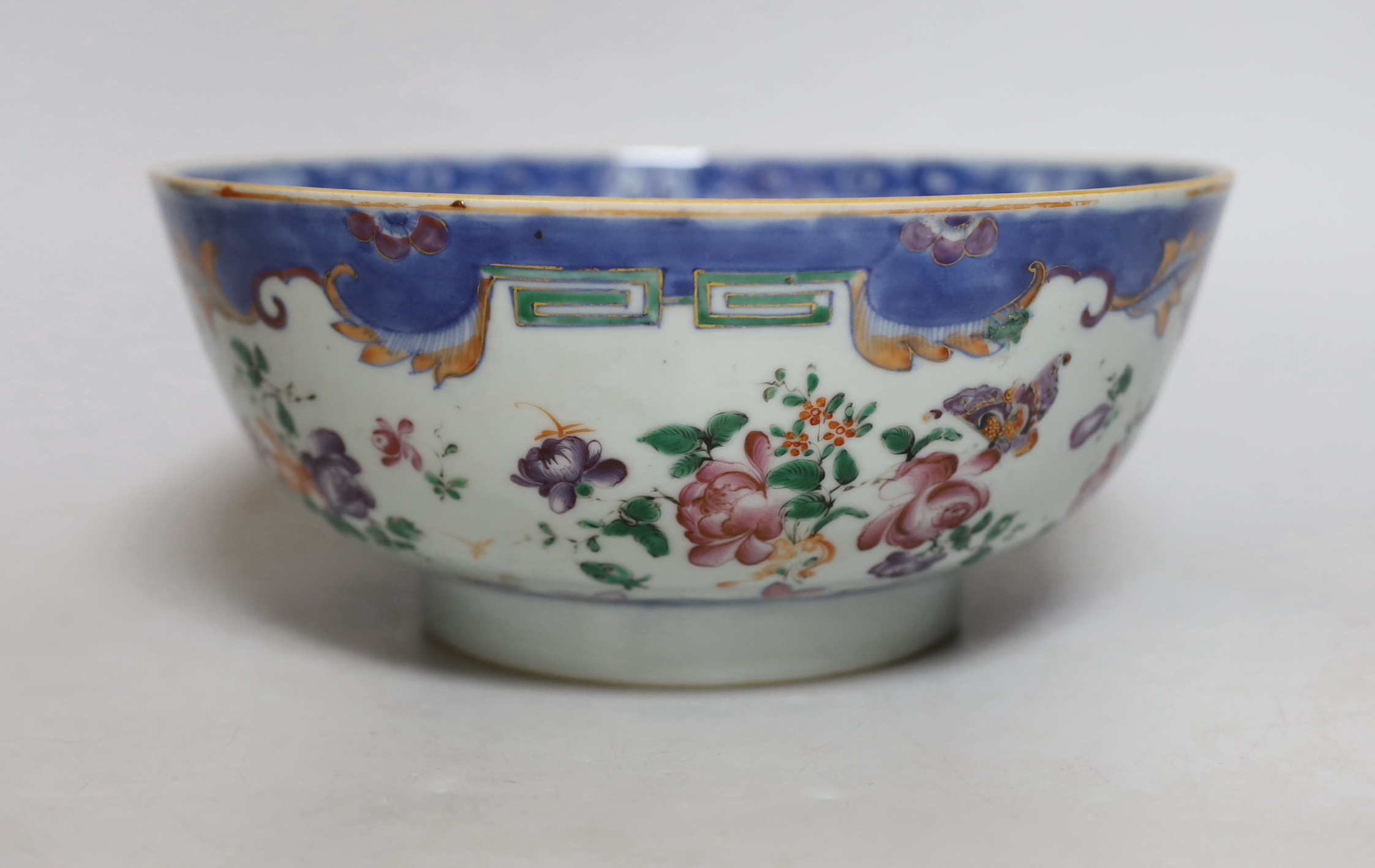 A Chinese famille rose bowl, Qianlong period, painted with insects amongst flowers, 23cm in diameter